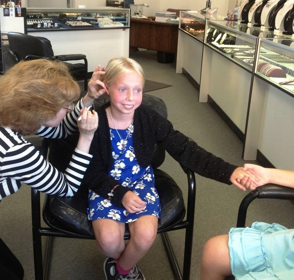 Brave while Janet Rothstein plans ear piercing